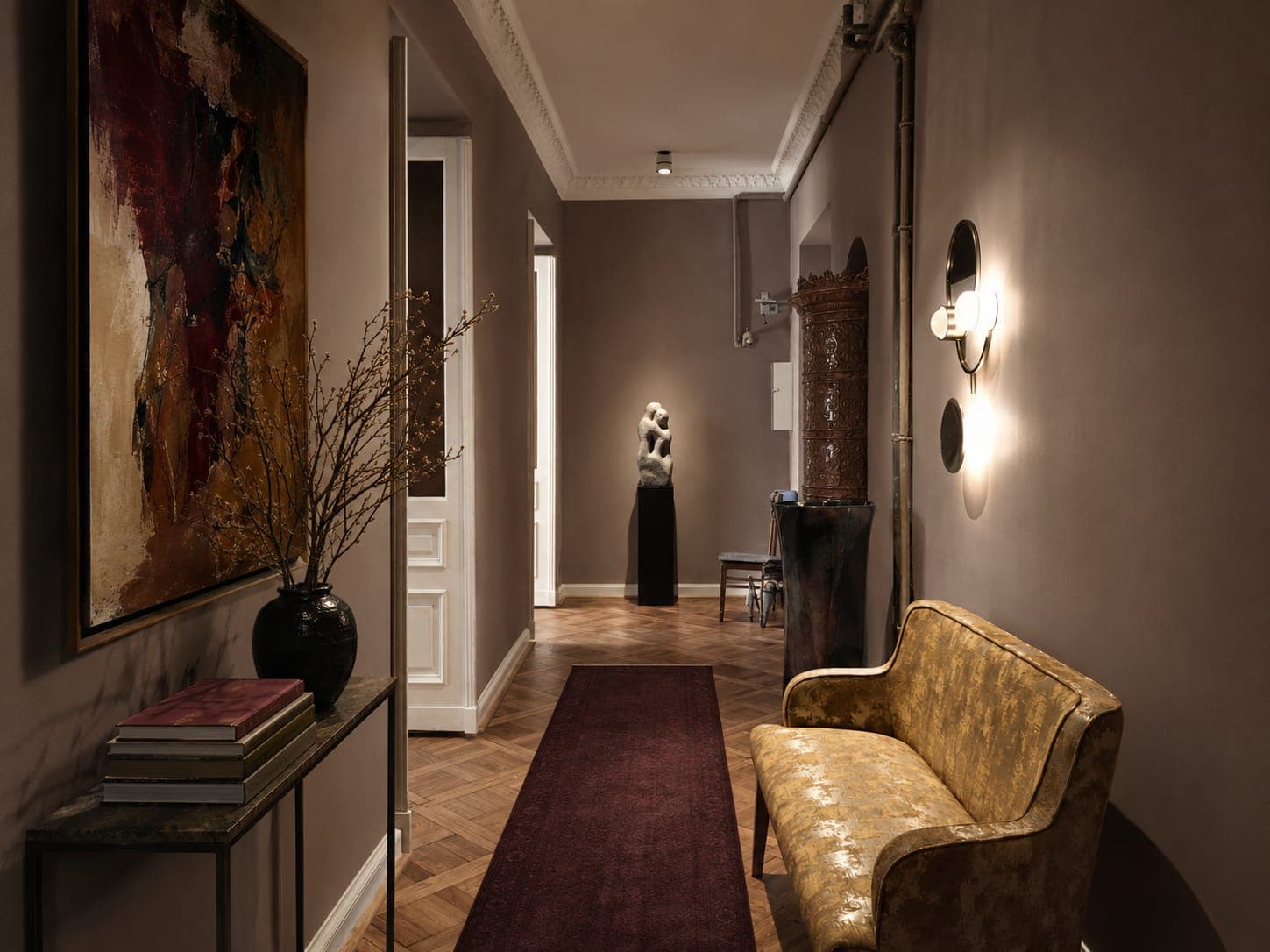 Hallway with herringbone parquet, a burgundy runner and a yellow settee, studio on Koszykowa in Warsaw