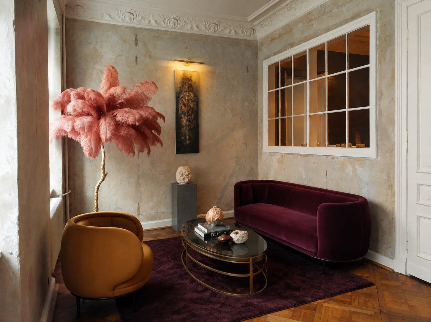 Bordowa sofa, żółty fotel i różowa lampa z piór, studio przy Koszykowej w Warszawie