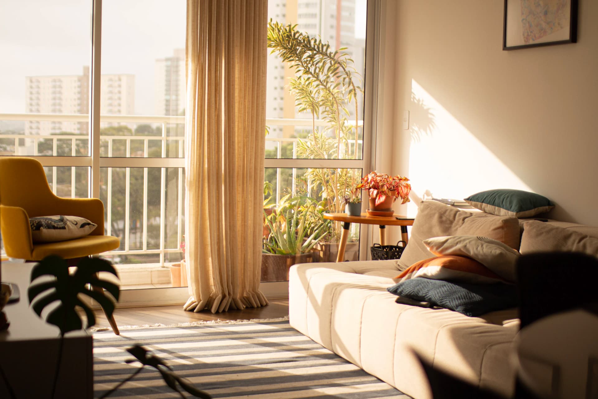 Living room with a sofa, balcony and city view after apartment fit-out in Warsaw